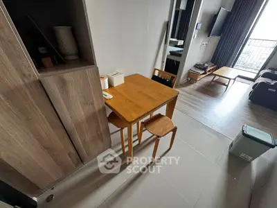 Modern apartment interior with wooden dining set and balcony view
