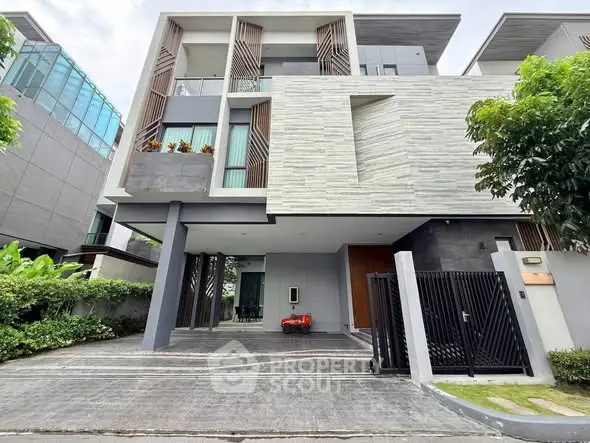 Modern three-story house with sleek design and spacious driveway in upscale neighborhood.