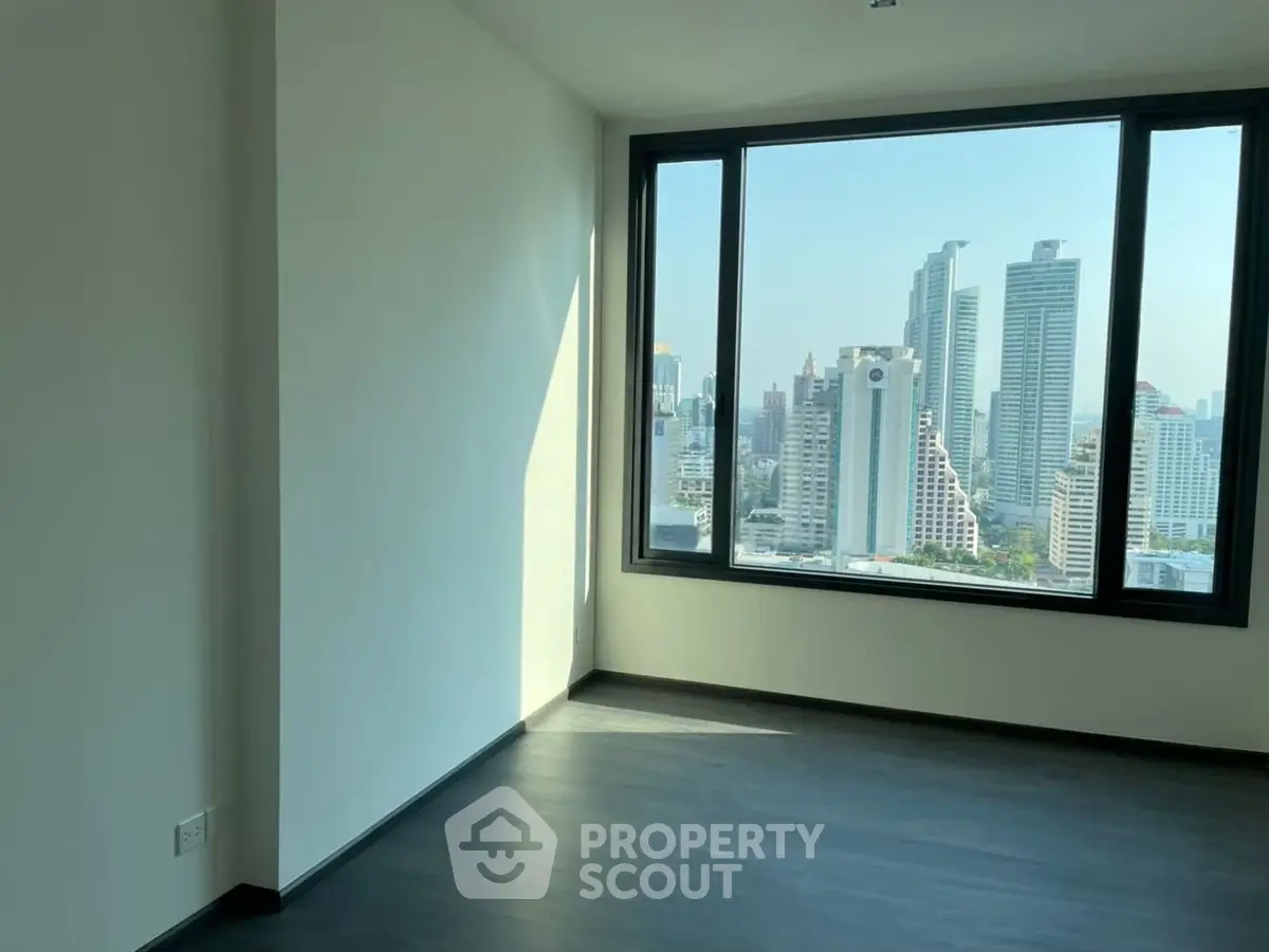 Spacious corner unit with stunning city view from large windows, perfect for modern living.