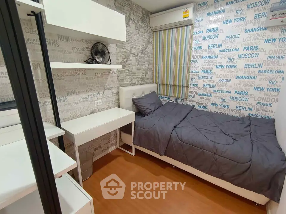 Modern bedroom with stylish wallpaper and compact design, featuring a cozy bed and functional workspace.