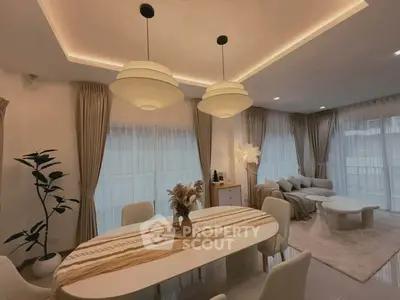 Elegant modern living room with stylish dining area and cozy seating, featuring soft lighting and contemporary decor.