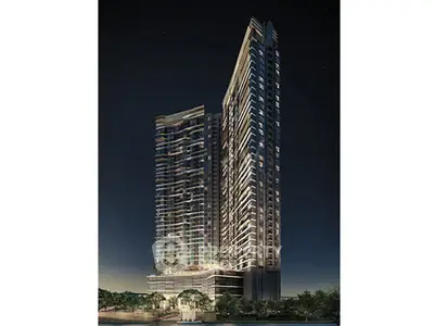 Stunning night view of modern high-rise residential towers with illuminated windows and sleek architectural design.
