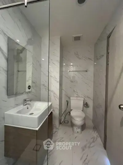 Modern bathroom with sleek marble tiles and contemporary fixtures