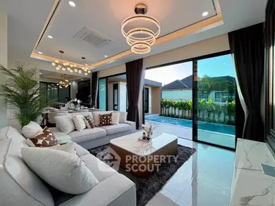 Luxurious living room with pool view, modern decor, and elegant lighting in a contemporary home.
