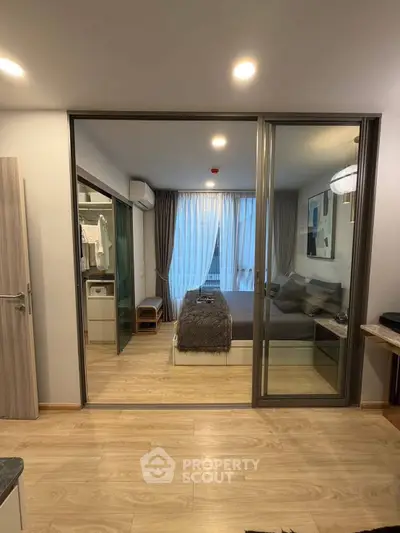 Modern bedroom with glass partition and cozy decor