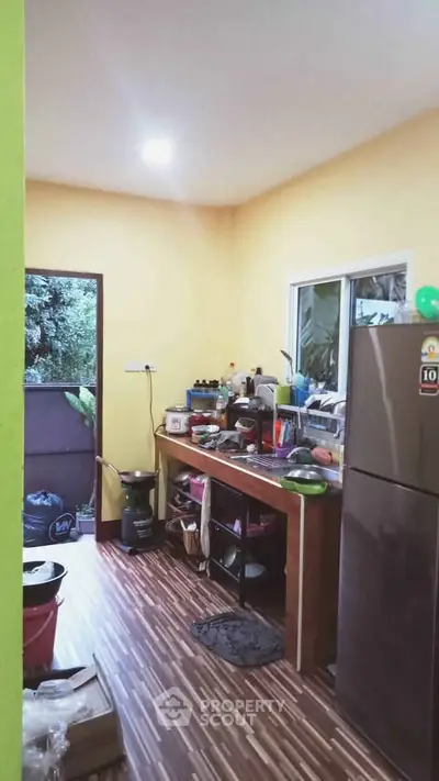 Cozy kitchen with modern appliances and wooden flooring, perfect for culinary enthusiasts.