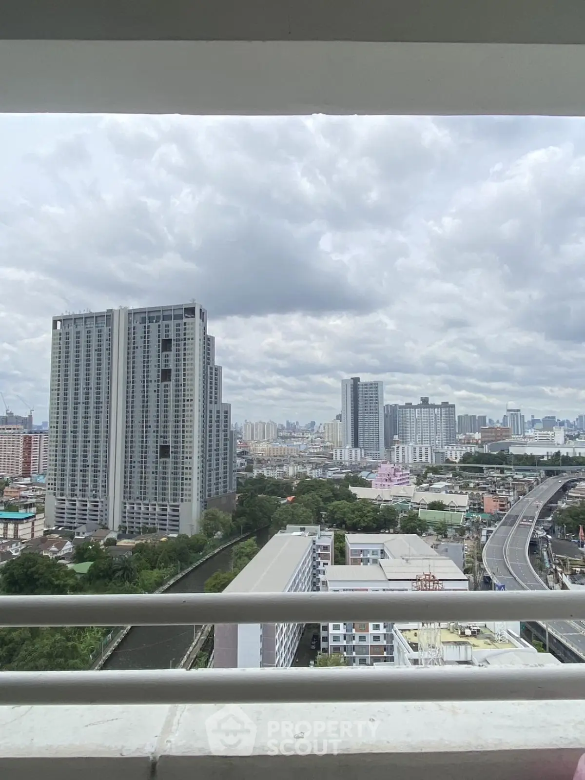 Stunning cityscape view from high-rise balcony showcasing modern urban living.