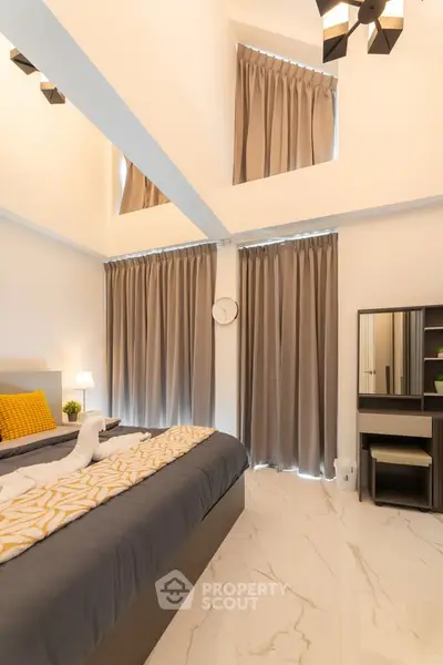 Luxurious bedroom with high ceilings and elegant decor