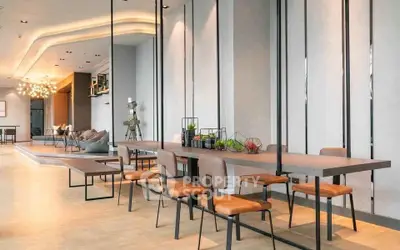 Modern open-plan living area with stylish dining setup and contemporary decor.