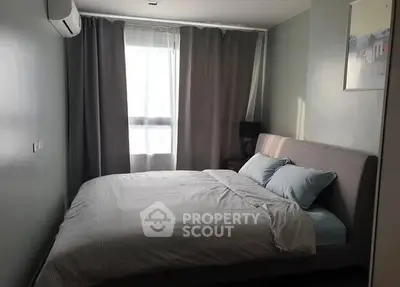 Cozy bedroom with natural light and modern decor, featuring a comfortable bed and elegant curtains.