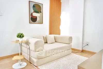 Modern living room with stylish sofa and abstract art, perfect for contemporary living.