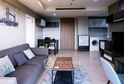 Modern living room with stylish furniture and in-unit washing machine