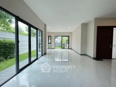 Spacious modern living room with large windows and garden view