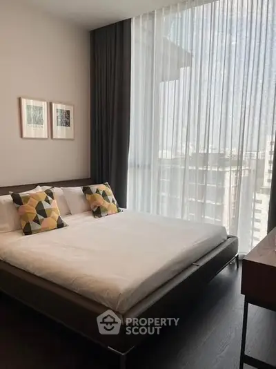 Modern bedroom with large window and stylish decor in urban apartment