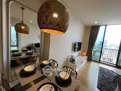 Modern living room with stylish dining area and city view balcony in high-rise apartment.