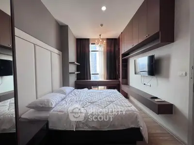 Modern bedroom with elegant decor, featuring a wall-mounted TV and ample storage space.