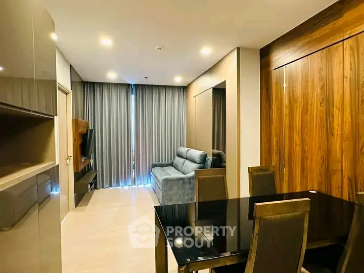 Modern living room with sleek furniture and elegant dining area, perfect for urban living.