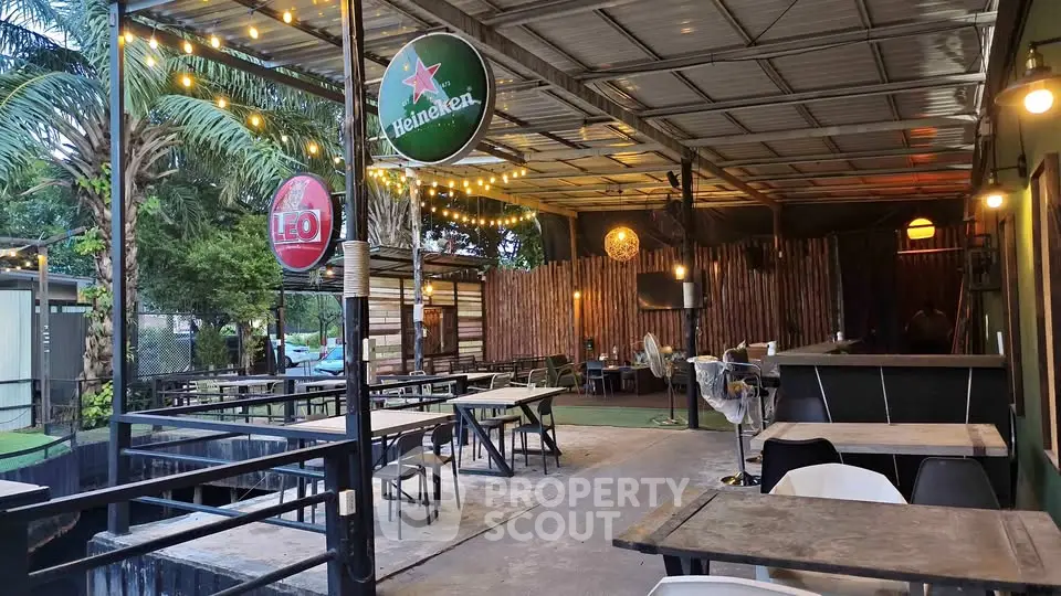 Charming outdoor dining area with rustic decor and ambient lighting, perfect for social gatherings.