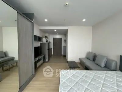 Modern studio apartment with sleek design and open layout, featuring a cozy living area and stylish furnishings.
