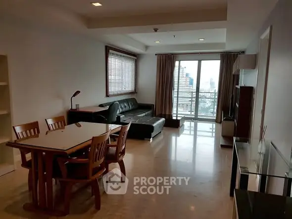 Spacious living room with modern furniture and city view from large windows.