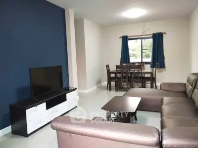 Spacious living room with modern furniture and dining area, featuring a large window for natural light.