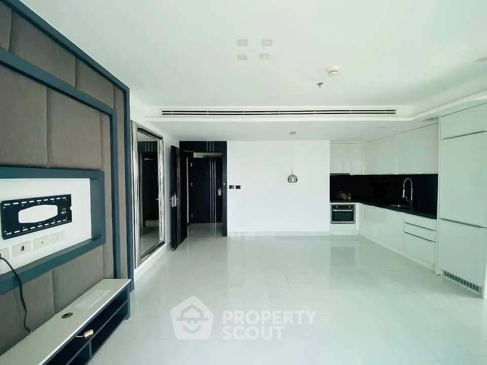 Spacious modern living room with sleek kitchen and built-in entertainment unit