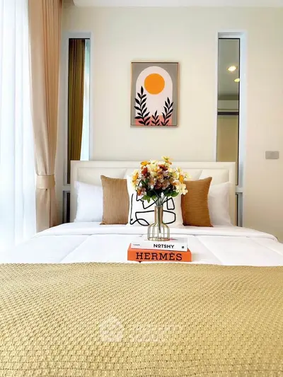 Elegant bedroom with stylish decor and cozy ambiance, featuring a modern bed and chic artwork.