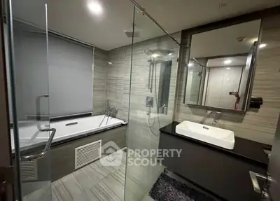Luxurious modern bathroom with glass shower and sleek bathtub