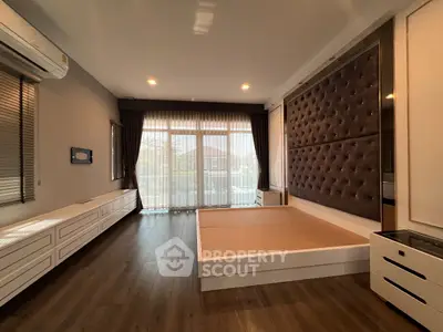 Spacious bedroom with modern design and large windows for natural light