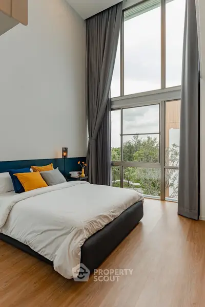 Luxurious bedroom with floor-to-ceiling windows and scenic view