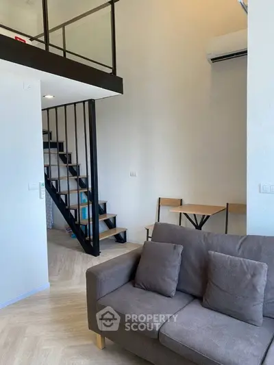 Modern loft apartment with cozy living area and stylish staircase