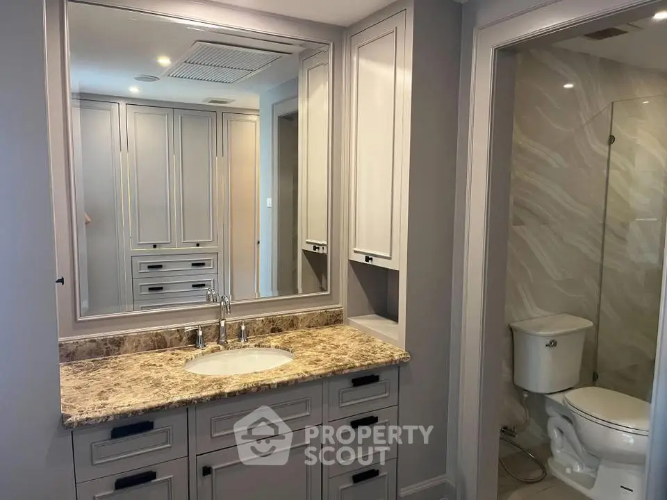 Luxurious bathroom with marble countertop and elegant cabinetry