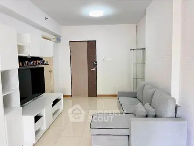 Spacious living room with modern furniture and entertainment center