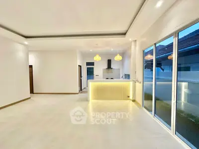 Spacious modern living room with open kitchen and large windows