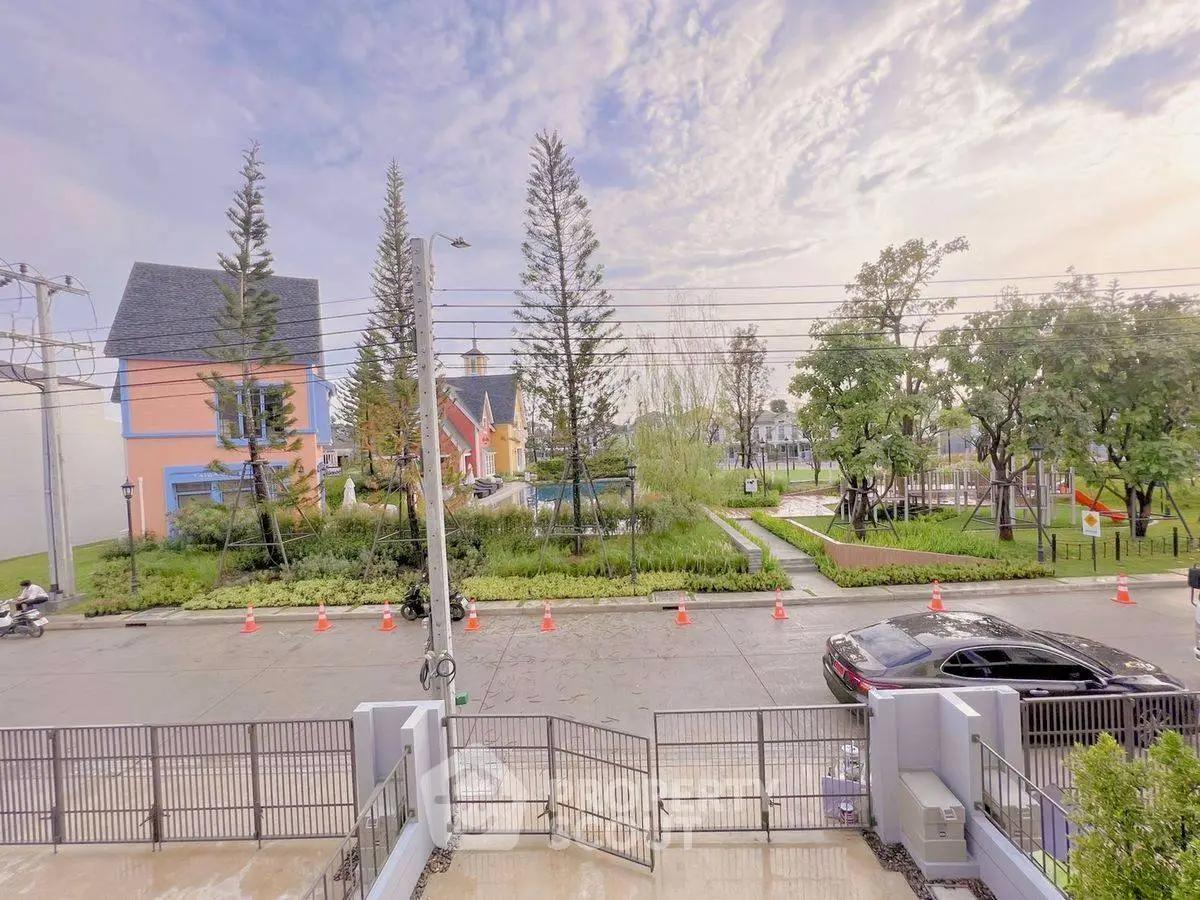 Charming suburban neighborhood view with colorful houses and lush greenery.