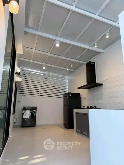 Modern kitchen with sleek appliances and open layout in a stylish home.