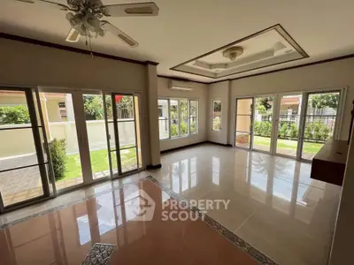 Spacious living room with large windows and garden view in modern home