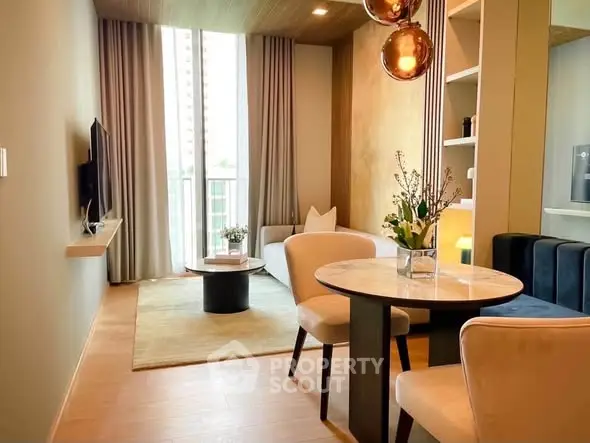 Modern living room with elegant decor, large window, and stylish furniture in a cozy apartment.