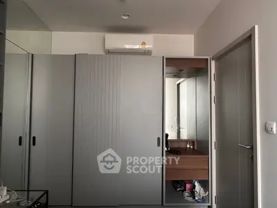 Modern bedroom with sleek wardrobe and air conditioning unit