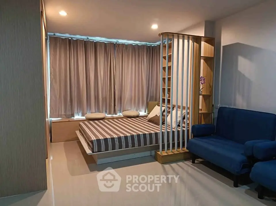 Modern bedroom with stylish partition and cozy seating area