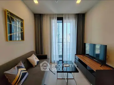Modern living room with stylish decor and city view from window.