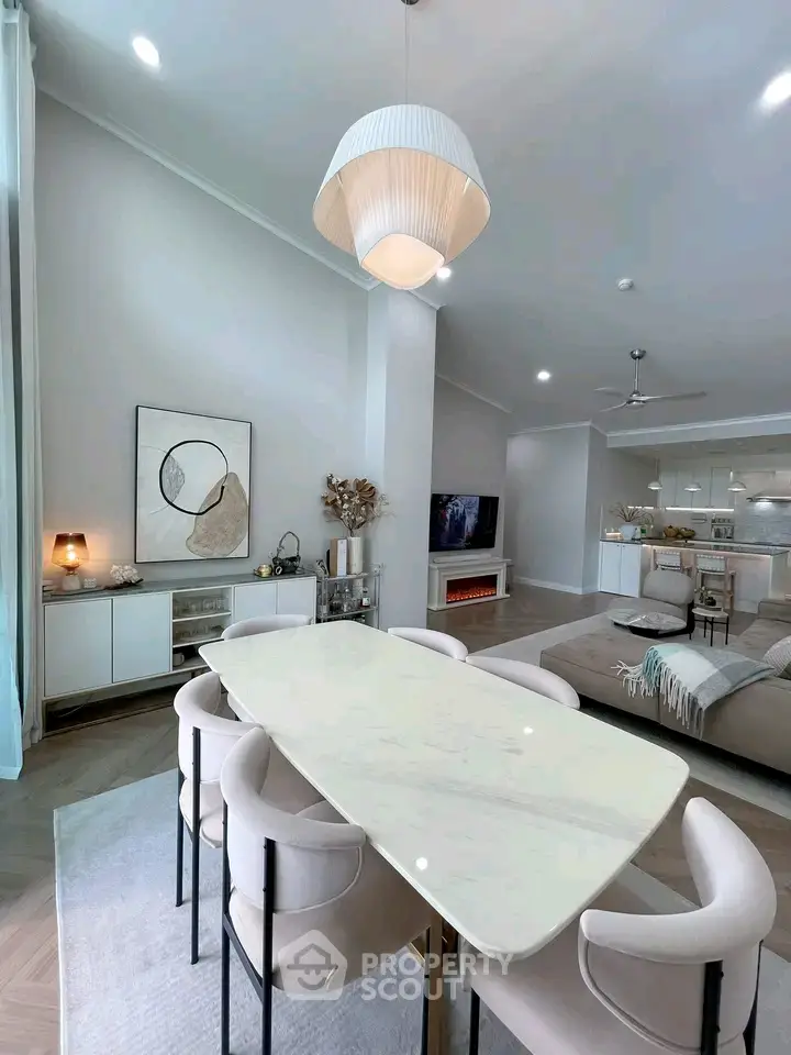 Elegant open-plan living and dining area with modern decor and ample natural light.