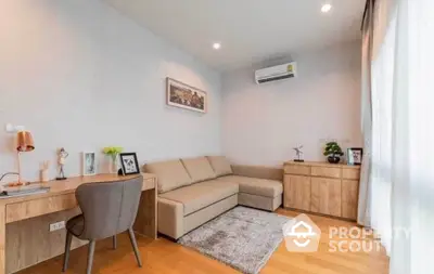 Modern study room with cozy sofa and wooden desk in bright apartment