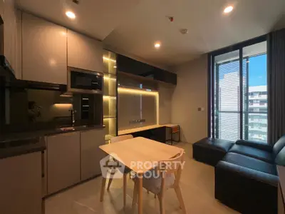Modern apartment interior with sleek kitchen and cozy dining area