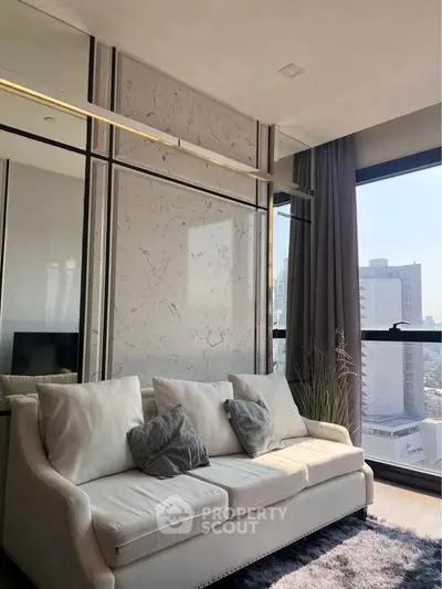 Modern living room with elegant sofa and large window offering city view