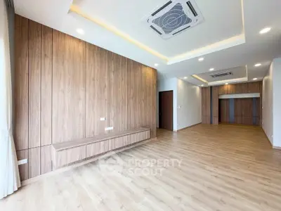 Spacious modern living room with wooden flooring and ceiling air conditioning