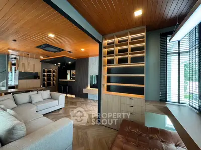 Spacious modern living room with wooden ceiling and built-in shelves