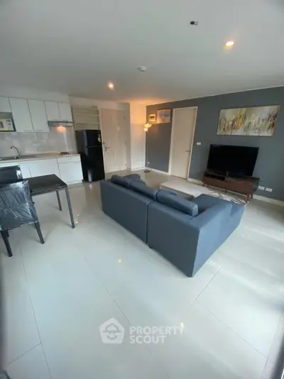 Modern open-plan living room with sleek kitchen and stylish decor