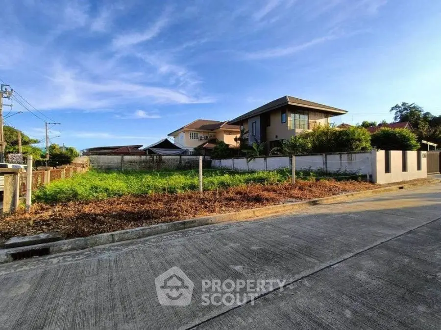 Spacious residential plot with modern house and lush greenery