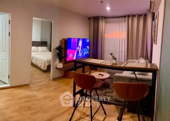 Modern living room with open layout and cozy bedroom view